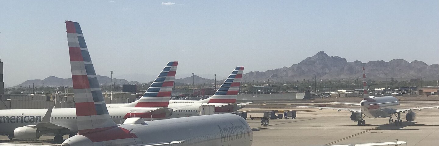 American Airlines jets on the tarmac under desert mountains
