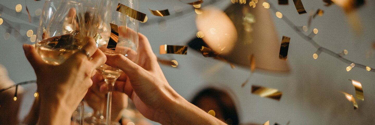 Hands raising champagne flutes in a toast
