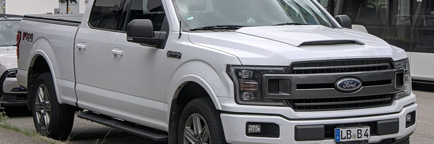 White Ford F-150 with the Ford oval on the grille