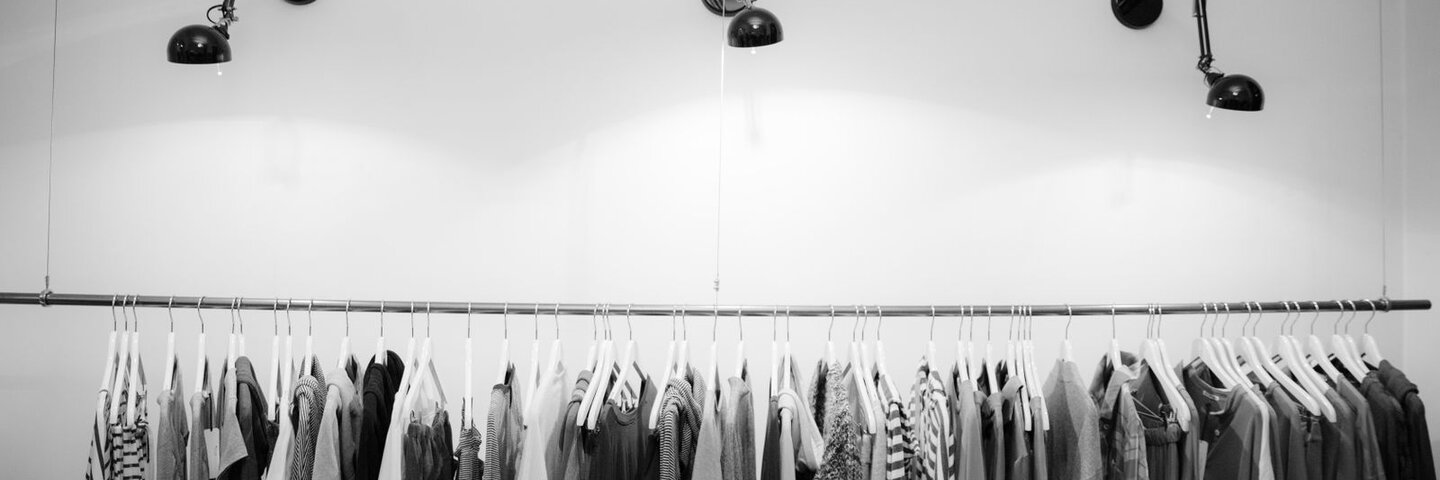 Clothes hanging on a boutique rack in black and white