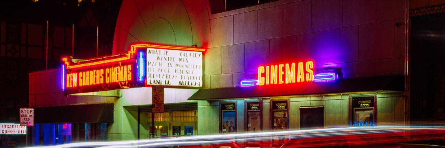 Neon cinema marquee at night