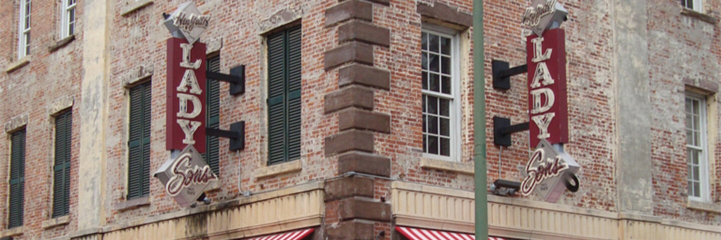 Lady & Sons restaurant signs on a brick corner in Savannah