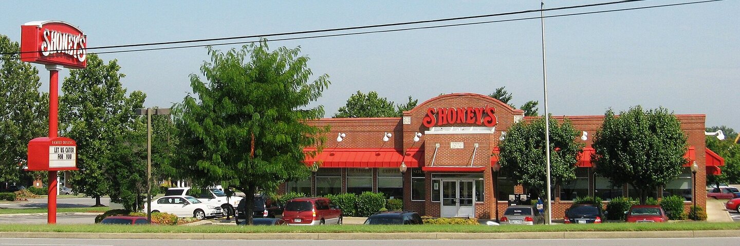 Shoney’s brick restaurant, red awnings, and roadside sign